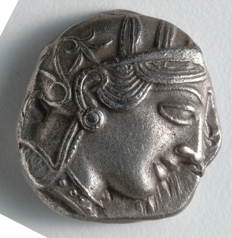 Athena in a crested helmet, facing right, with a large almond-shaped eye.