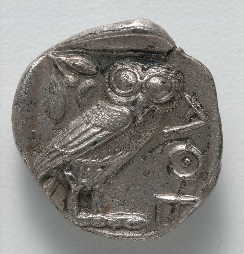 Silver Athenian tetradrachm: an owl faces outward above a square incuse, with olive, crescent and ΑΘΕ.