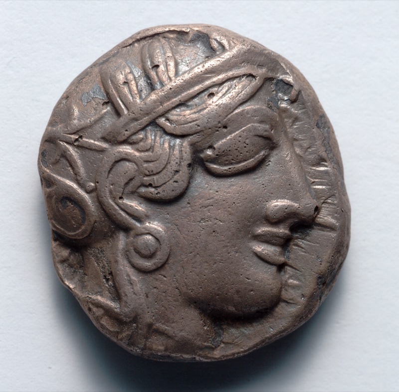 Athena’s helmeted head on an early classical Athenian silver tetradrachm.