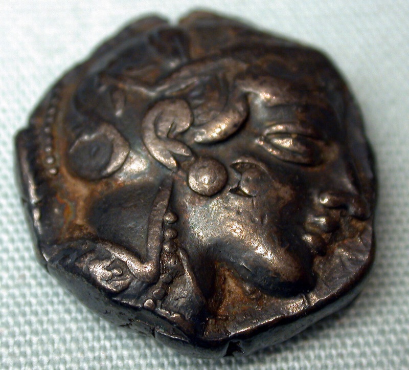 Athena facing right on a silver tetradrachm in the Met, wearing a decorated helmet.
